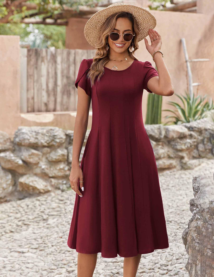 Belle robe midi femme – col rond, manches bouffantes et poches, ligne A élégante